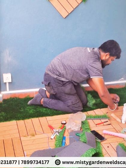 Our team at work, demonstrating the precision required to install custom flooring in a small and uniquely shaped balcony space.
