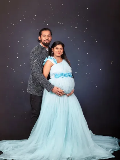 We make sure both of you look great together. This mom-to-be is wearing a lovely sky-blue gown, and we have a matching blazer for the dad-to-be to create a complete and coordinated look for your maternity photoshoot.