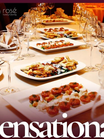 A beautifully set dining table featuring a variety of our sensational appetizers. We believe catering is about crafting unforgettable moments through culinary excellence and exquisite presentation.