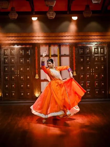 A dynamic pose from a photoshoot for a 'Tarana' performance. The lighting and movement create a powerful and theatrical image.