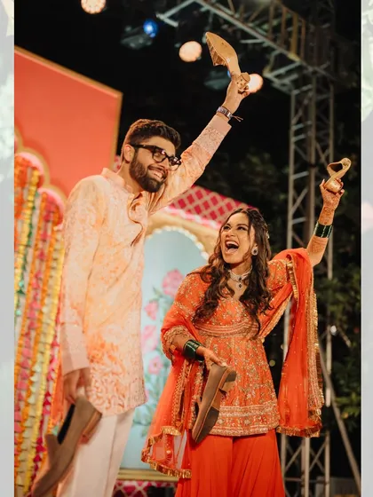 The fun and games that make a wedding personal. Here, the couple proudly shows off the groom's shoes after a successful 'joota chupai' during the Haldi festivities.