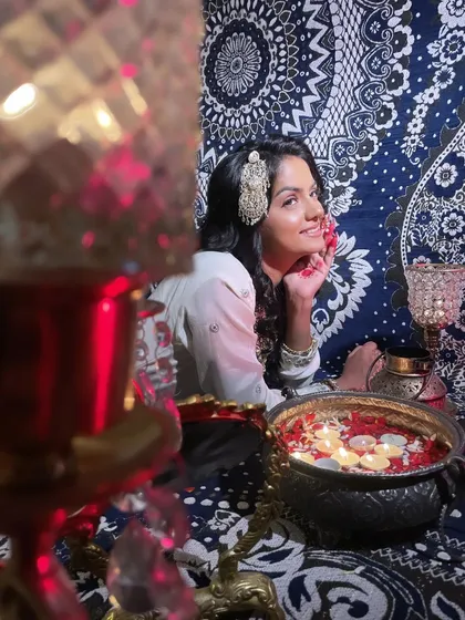 The lighting and ambiance were key to this 'Heeramandi' shoot. The warm candlelight creates a soft, romantic glow, highlighting the model's beautiful features and intricate hair accessory.
