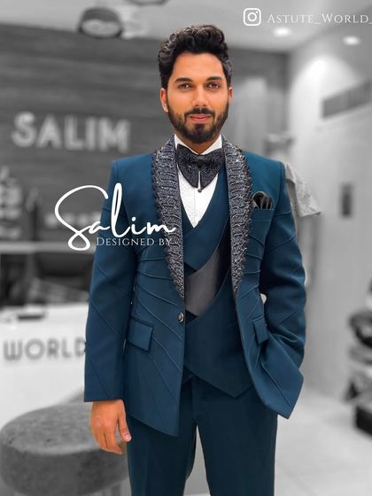 A client wearing a teal three-piece suit. The jacket features textured lapels and structured paneling, offering a modern twist on a classic three-piece.