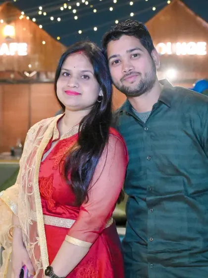 A couple's portrait taken at an outdoor cafe in the evening, with soft lighting creating a romantic mood.