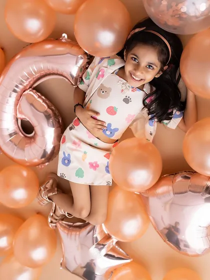 Floating in a sea of balloons! This overhead shot is a fun and creative way to celebrate a 6th birthday, full of color and happiness.