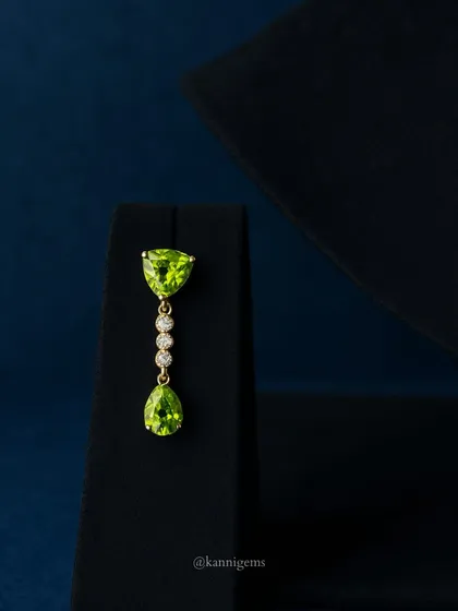 The matching peridot and diamond drop earring, designed to perfectly complement the necklace while being elegant enough to wear on its own.