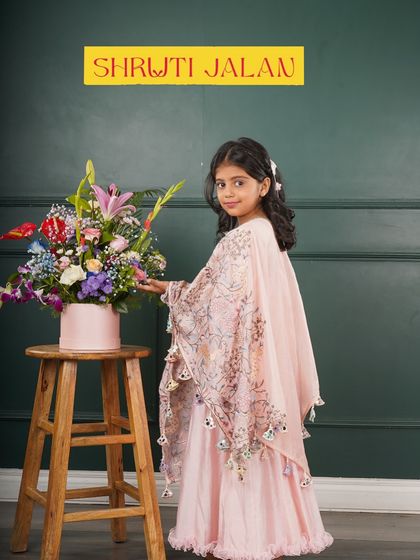 Another look at the sister cape gowns in pink and blue. These outfits are designed to be as magical as their bond.