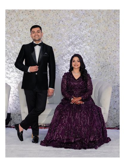 A formal portrait of the couple at their reception. Their elegant attire and poised stance create a look of classic sophistication.