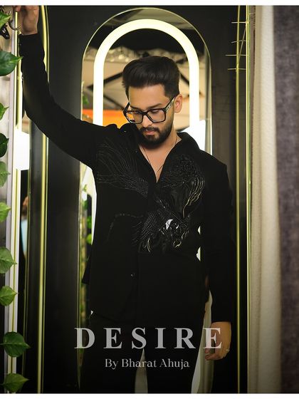 A full view of the subtle power of this black shirt. It is designed for the man whose confidence is his primary accessory.