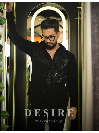 A pensive pose in the black-on-black embroidered shirt. It's a look that is both charming and full of edge.