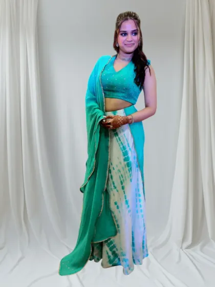 It brings me so much joy to see my clients happy in their custom outfits. I designed this vibrant tie-dye skirt and mirror-work halter blouse for a sangeet celebration. The outfit was crafted to be as full of life and personality as she is, perfect for dancing the night away.