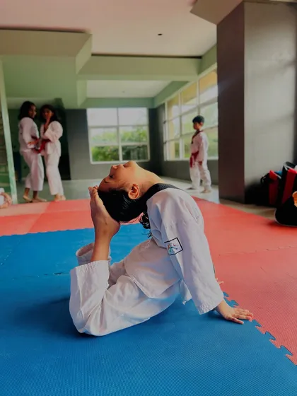 This student holds a deep backbend, a testament to the incredible flexibility developed through our rigorous stretching routines.