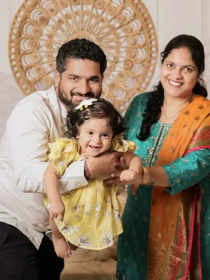 A candid, joyful moment from the same session. We love capturing the unposed interactions between parents and their children, showing the pure happiness of being together.