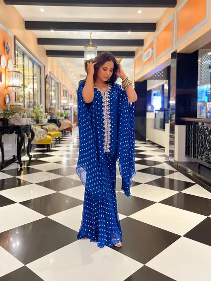 This shot shows the full, flowy silhouette of my blue sharara and cape set. It was the perfect decision to ditch the lehenga for this.
