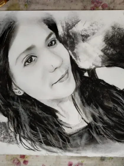 A soft charcoal sketch capturing a gentle, smiling expression.