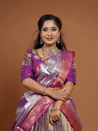 A full-length view of the bride, showing how the silver-finish jewellery creates a modern and sophisticated look.