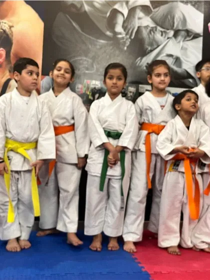 This is our team of young fighters. From beginners to advanced students, they train together, respect each other, and grow together. The different colored belts show their journey and dedication.