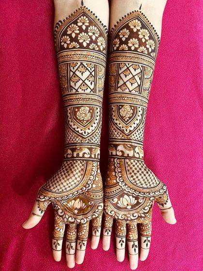 A beautiful example of a traditional bridal mehendi with floral bands, elephant motifs, and classic Indian patterns. The design is both intricate and elegant.