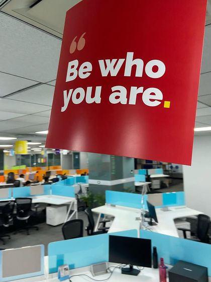 Our office decorated for Pride Month with a banner that reads "Be who you are." This is a central tenet of our company culture.