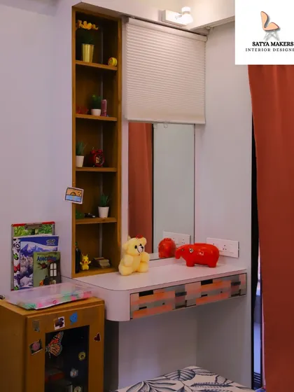 A charming and practical vanity or study corner in a child's room, with open shelving for easy access to books and toys.
