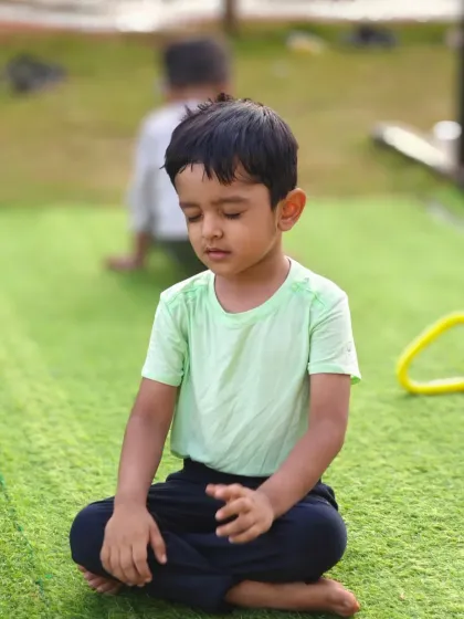 A young boy practices mindful breathing. We teach kids that calisthenics is not just about exercise but also about connecting the mind and body.