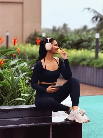 A candid moment in a full black activewear set from Boldfit. This shows the gear in a relaxed, post-workout setting, emphasizing comfort and style.
