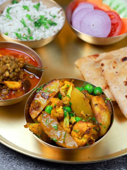 A classic comfort meal: aloo gobi matar, whole lentil curry, rice, and roti. It’s a staple in our rotating menu because it’s loved by so many.