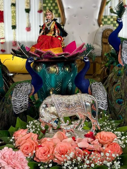 A beautiful centerpiece with a silver cow and calf, surrounded by fresh flowers.