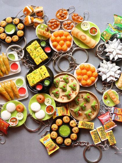 A huge collection of my recent keychain orders, featuring a wide variety of Indian dishes.