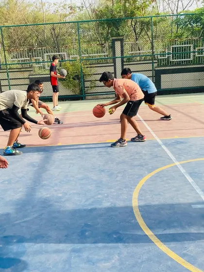 Fundamentals are everything. Here, our players are locked in on a ball-handling drill, improving their control and coordination. Mastering these basics is key to becoming a versatile player.
