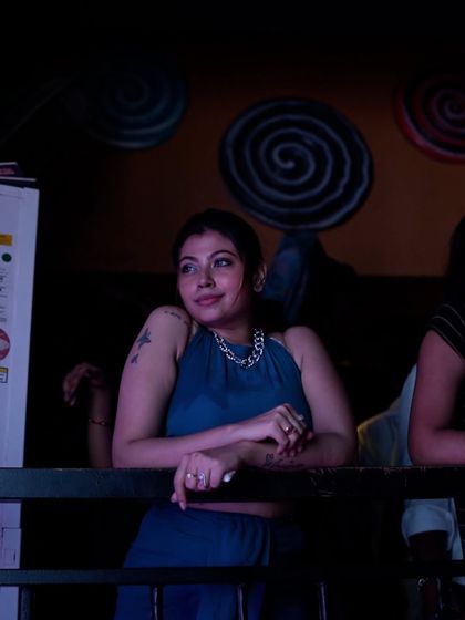 A guest enjoying the vibe from the balcony at Sugar Factory. Even if you're not on the dance floor, you're still part of the experience.