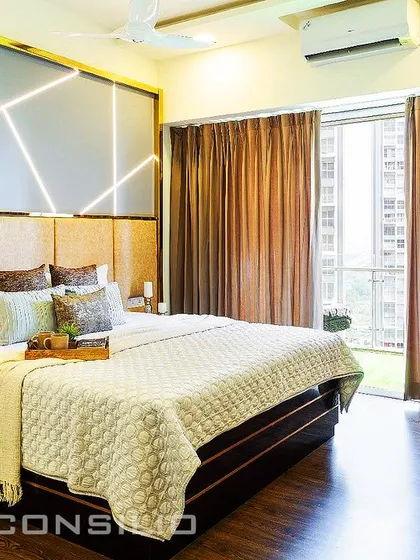 This master bedroom features a dramatic headboard with integrated geometric profile lighting. It serves as both a light source and a stunning piece of wall art.