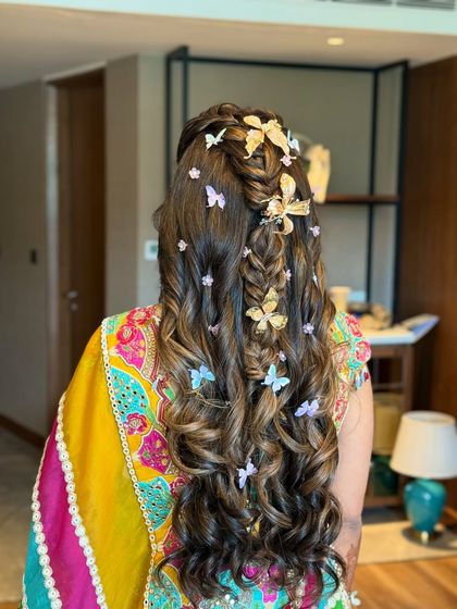 The complete Mehandi look with the butterfly hairstyle, showing how it pairs with a colorful and vibrant outfit.