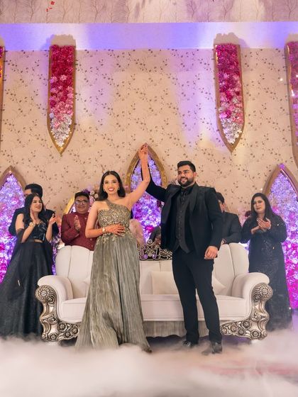 The couple's grand entry at their engagement party, complete with cold pyro and smoke for a dramatic effect.