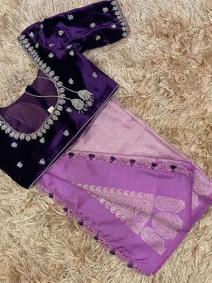 The back of the violet velvet blouse, showing the detailed silver embroidery along the neckline and the delicate tassels.