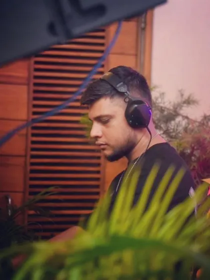 A candid profile shot of me focused on my mix, surrounded by tropical plants at The Park Bangalore.