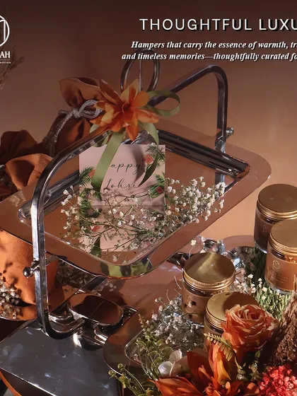 "Thoughtful Luxury." This image shows our Lohri hamper, complete with a two-tiered server, gourmet treats in jars, and festive decorations, all designed to carry the essence of warmth and tradition.
