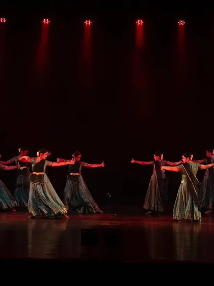 A dynamic group movement from 'Ek Anant'. The flowing costumes and synchronized turns create a beautiful visual spectacle on stage.