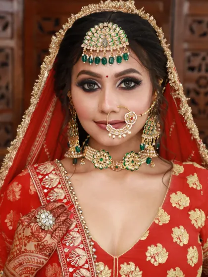 A classic bridal portrait. This look features sharp, winged eyeliner and a flawless base, perfect for a traditional red lehenga.