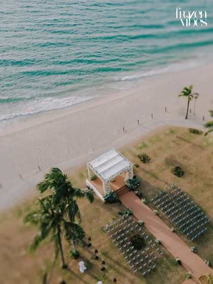 An aerial view of a beach wedding ceremony setup in Phuket. This shot captures the beauty of the location and the anticipation before guests arrive.
