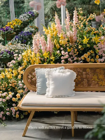 Where soft ruffles meet a garden in bloom. These simple white and blue ruffled cushions were the perfect complement to the lush, floral-filled setting of the greenhouse Haldi.