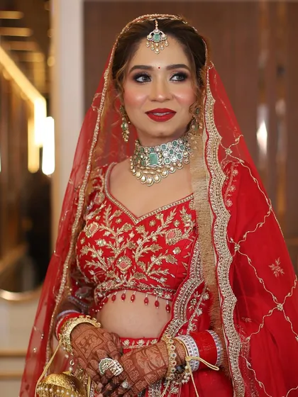 The perfect bridal portrait. Her makeup looks fresh and radiant, with a focus on her bright smile and expressive eyes.