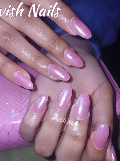 A beautiful set of almond-shaped nails with a pearlescent pink chrome finish for a subtle glow.