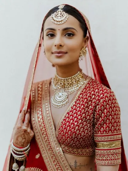 A classic red bridal look will never go out of style. For this bride, I created a soft glam look with defined eyes and a neutral lip, ensuring her natural beauty was the focus. This timeless makeup is perfect for the main wedding ceremony.