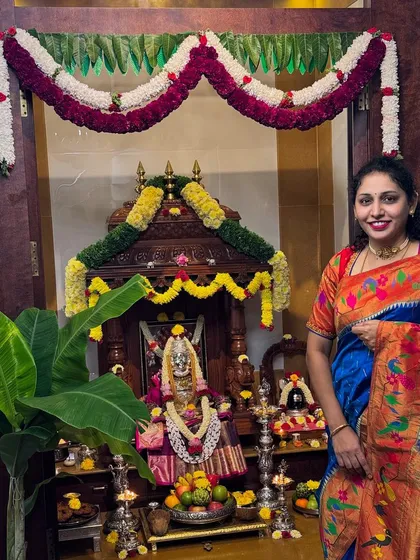 Our client Geetha celebrates Diwali at home, looking beautiful in a traditional Paithani silk saree in front of her pooja setup.