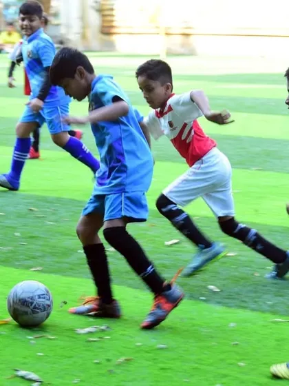 An intense moment from an Under 8 match, as players battle for possession of the ball.
