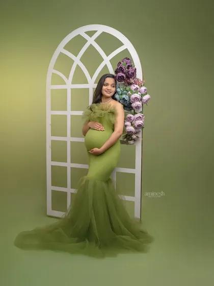 Using the same green gown, we switch to a white window prop adorned with flowers. This demonstrates the versatility of my studio setups to give you a variety of looks during your session.