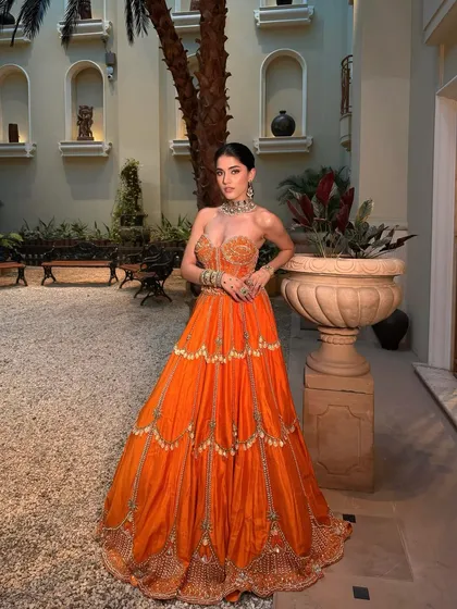 A full-length view of this sunshine-filled look. The makeup is designed to complement the vibrant outfit without overpowering it, perfect for a Mehendi.