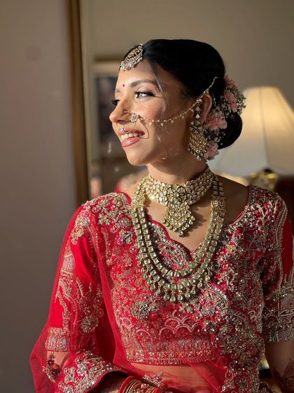 A side profile showing the elegant hair and the floral accessories that we incorporated into her look.