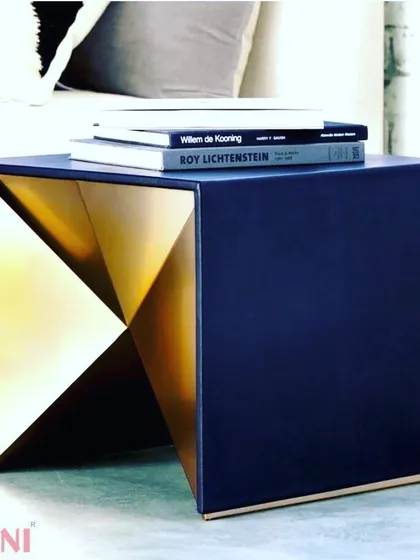A unique bedside or side table with a geometric, faceted gold interior. This piece is a perfect example of a small accent that can add a touch of glamour and artistry to a room.